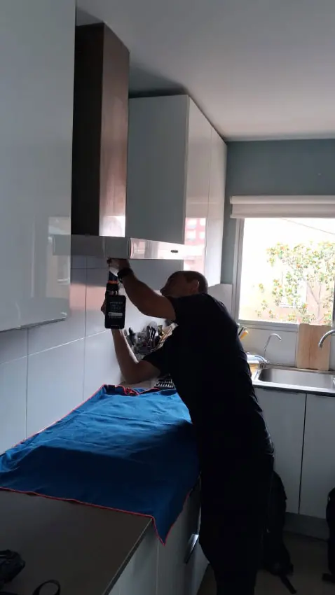 Instalación de un nuevo extractor de cocina de acero inoxidable.